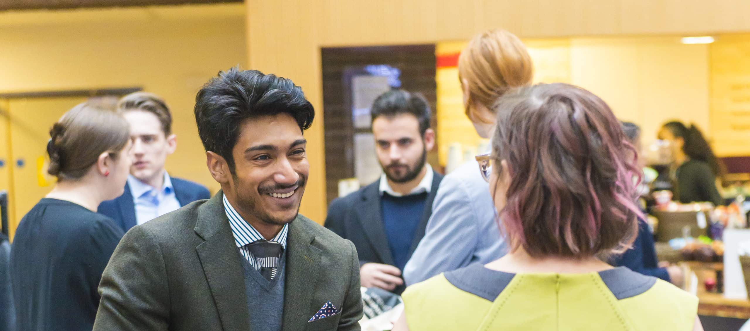 A student is smiling and talking to Kingston hub staff Annie at the Kingston Hub SIP Launch