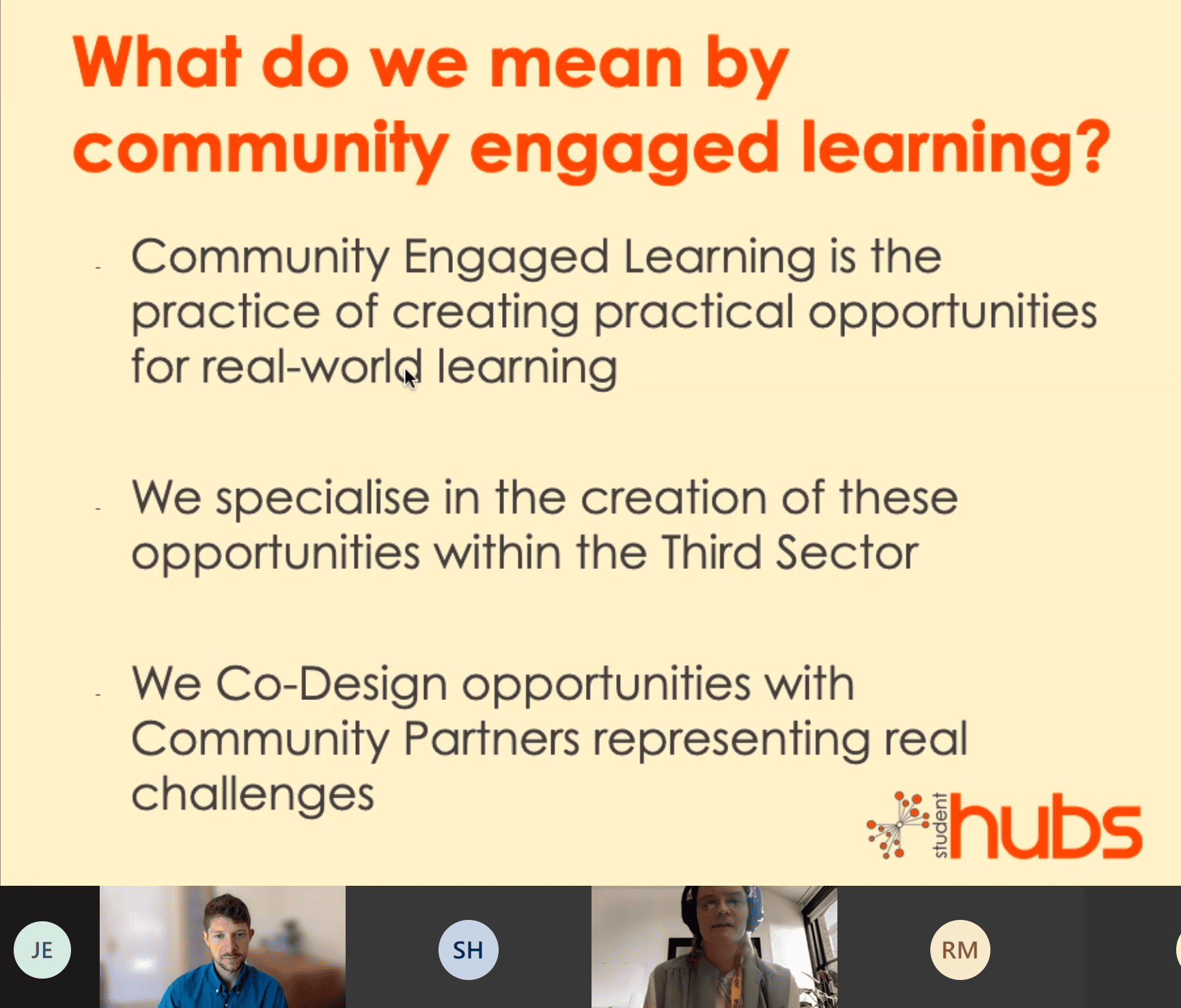 Screenshot of a presentation. The slide is pale yellow with an orange title reading "What do we mean by community engaged learning?". Below this black text reads "Community engaged Learning is the practice of creating practical opportunities for real world learning. We specialise in the creation of these opportunities within the Third Sector. We Co-Design opportunities with Community Partners representing real challenges. Below the slide you can see the two presenters looking at the screen. 