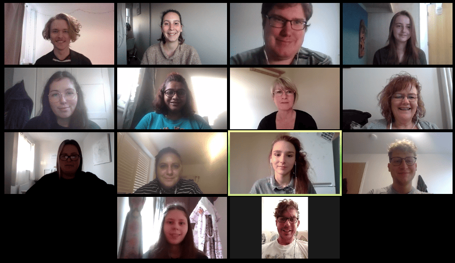 14 people smile at the camera in a video call