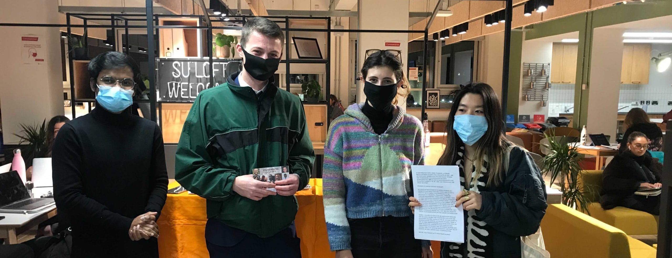 Four Students to Inspire participants look at the camera wearing masks.