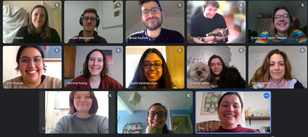 13 members of the Student Hubs staff team smile at the camera in a video all