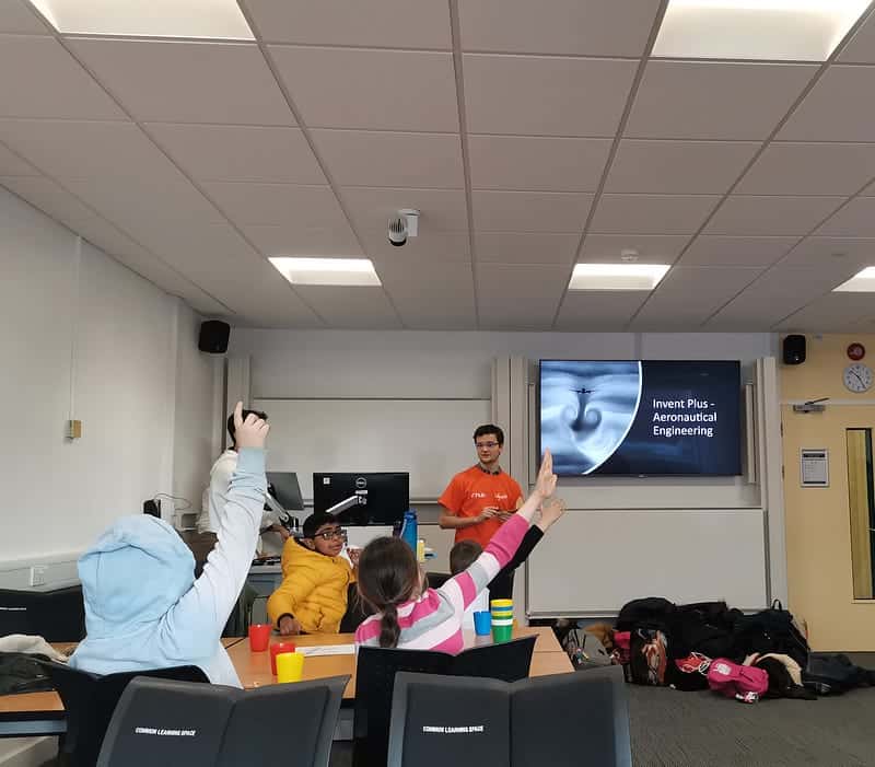 Voluneers delivering an aeronautical engineering session in a classroom