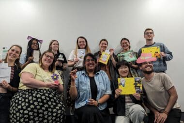 Staff team of Student Hubs smiling at the camera while showing their awards