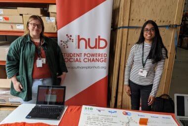 ID: Southampton Hub staff stand by a Student Hubs banner