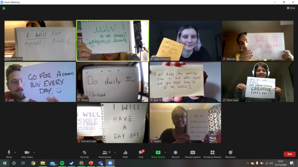 ID: Southampton team members and committee on a Zoom call, holding up pieces of paper with their intentions for I Will Week written on them. These include 'Go for a short run every day', 'I will put myself first', and 'I will have a day off'.